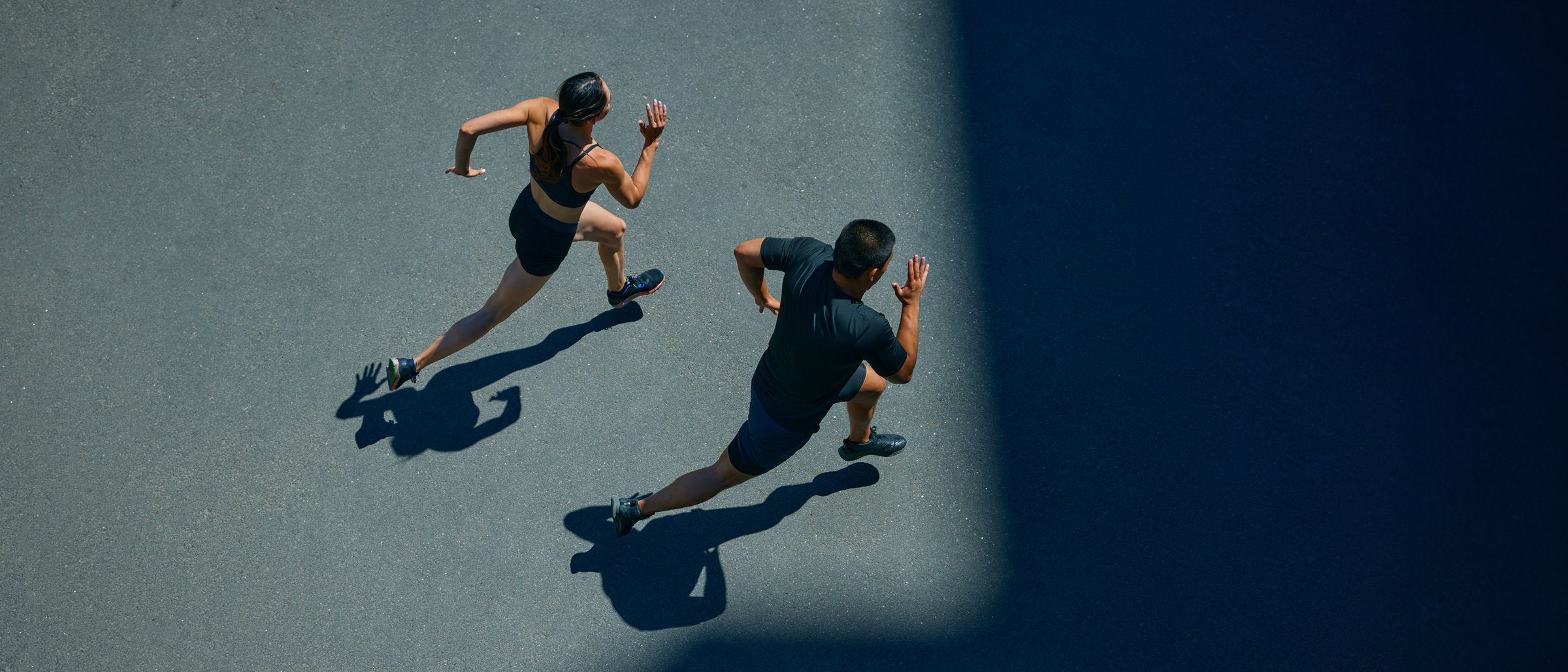 Two runners training on an open road